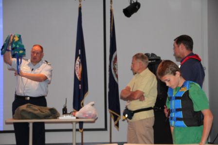 Volunteers try on lifejackets